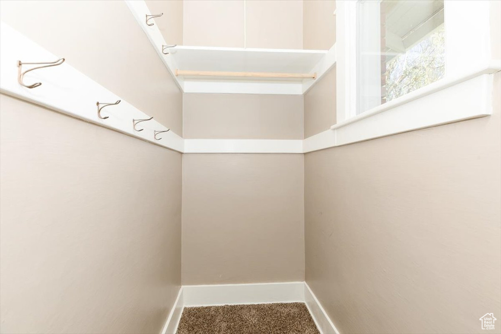 Interior space featuring baseboards and carpet
