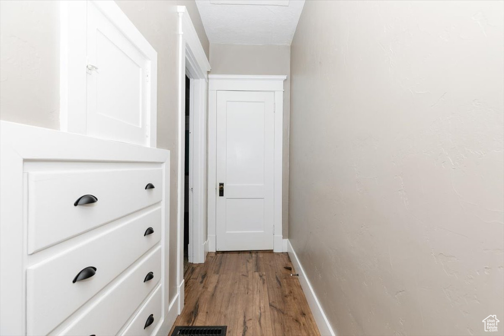 Hallway with baseboards and light wood-type flooring