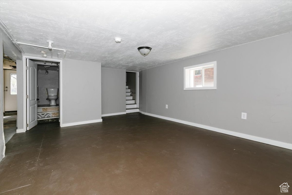 Basement featuring baseboards and stairs