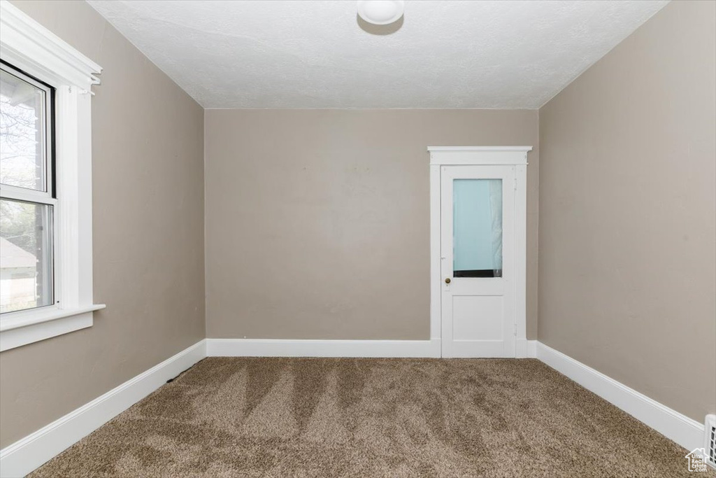 Empty room with baseboards and carpet flooring