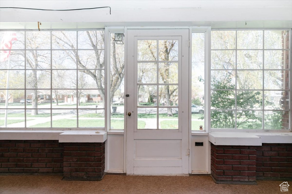 Doorway to outside with carpet floors