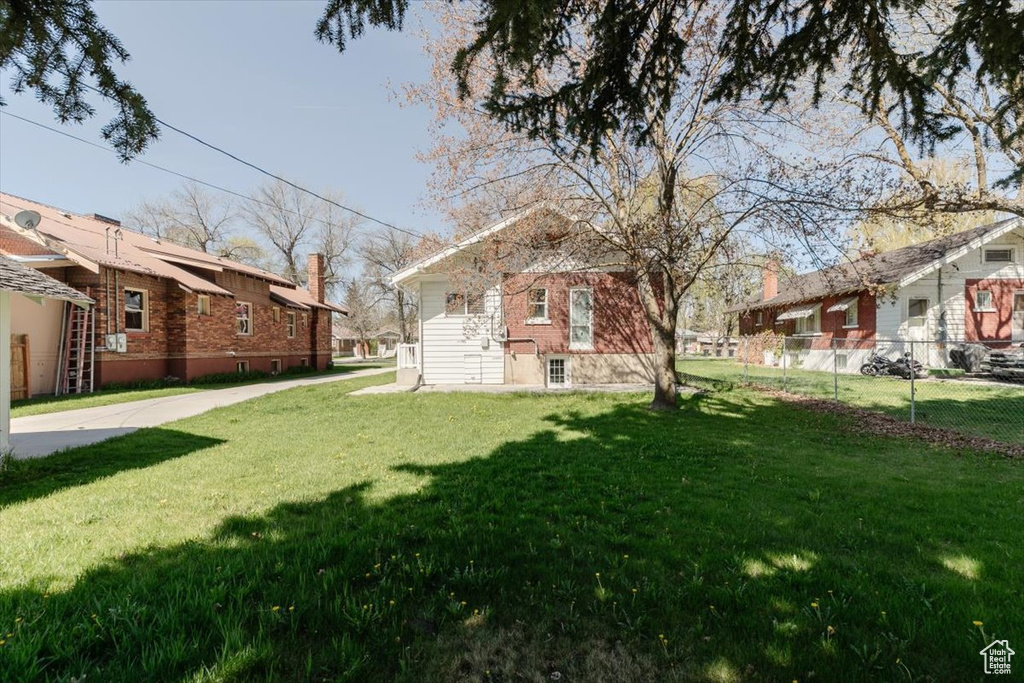 View of yard with fence and a residential view