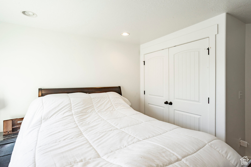 Bedroom featuring recessed lighting and a closet