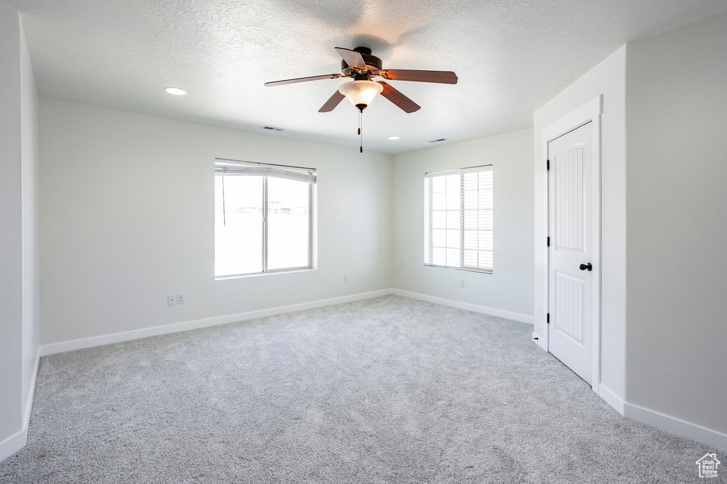 Spare room featuring recessed lighting, ceiling fan, carpet floors, and baseboards