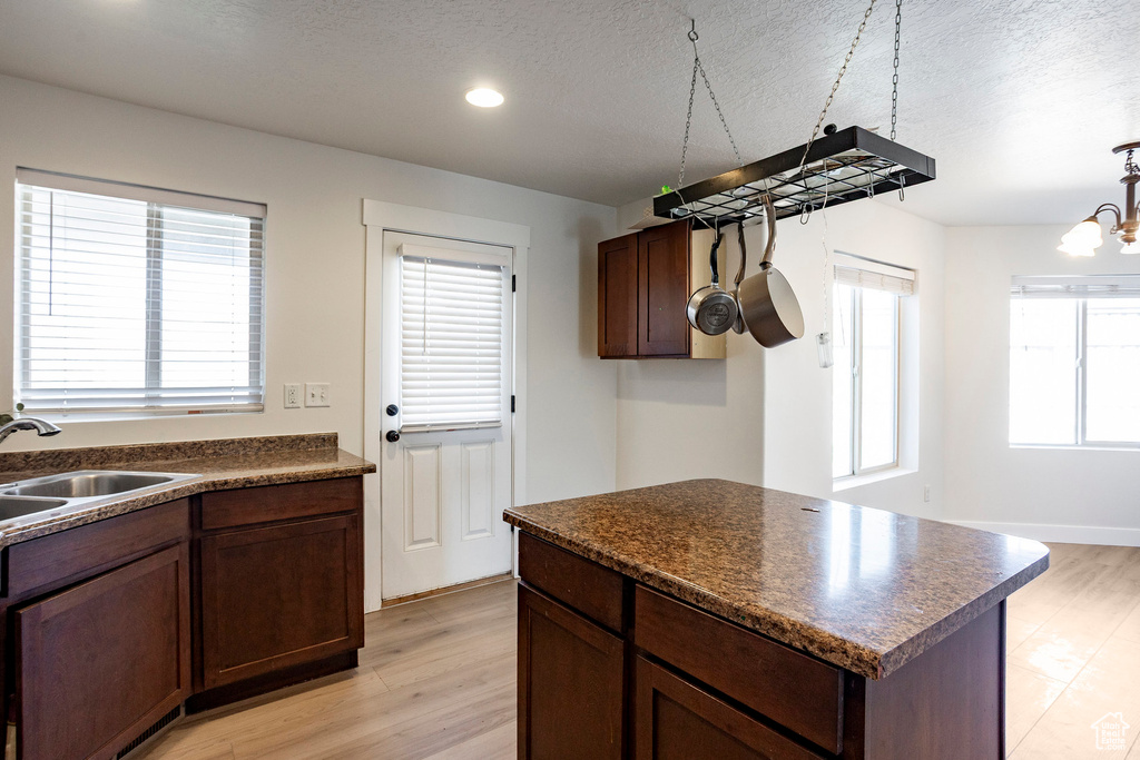 Kitchen featuring dark countertops, plenty of natural light, and a sink