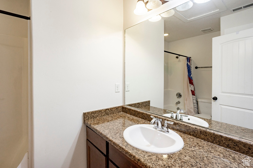 Full bath featuring shower / tub combo, visible vents, and vanity
