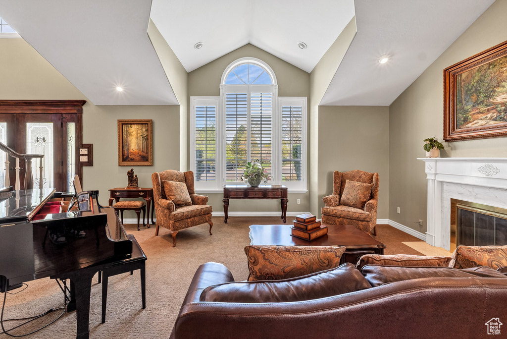 Carpeted living room with lofted ceiling and a fireplace