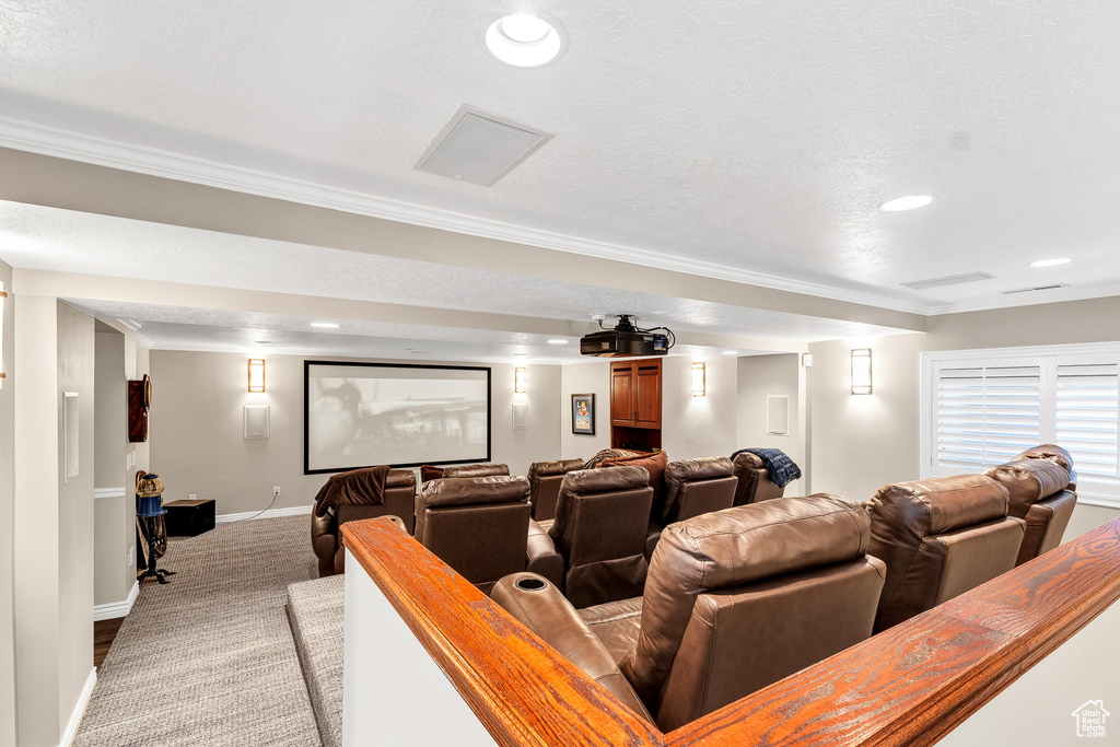 Home theater featuring baseboards, recessed lighting, light colored carpet, and crown molding