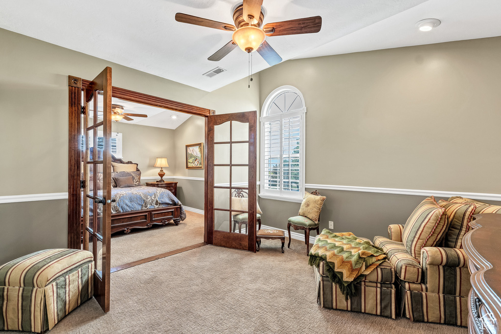 Bedroom featuring vaulted ceiling, visible vents, carpet, and ceiling fan