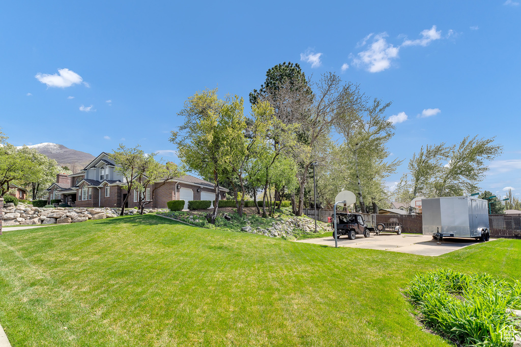 View of yard featuring a patio, fence, and a mountain view