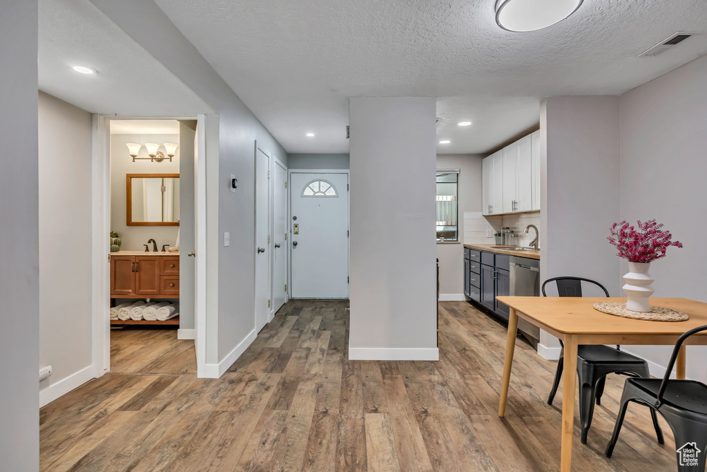 Dining space featuring wood finished floors, baseboards, and a textured ceiling
