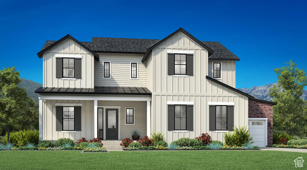Modern inspired farmhouse featuring board and batten siding, covered porch, a standing seam roof, roof with shingles, and a front yard
