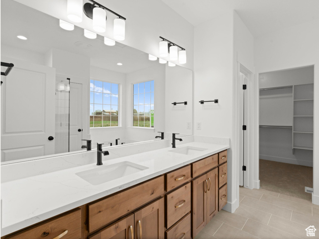 Full bathroom with tile patterned flooring, recessed lighting, double vanity, and a sink