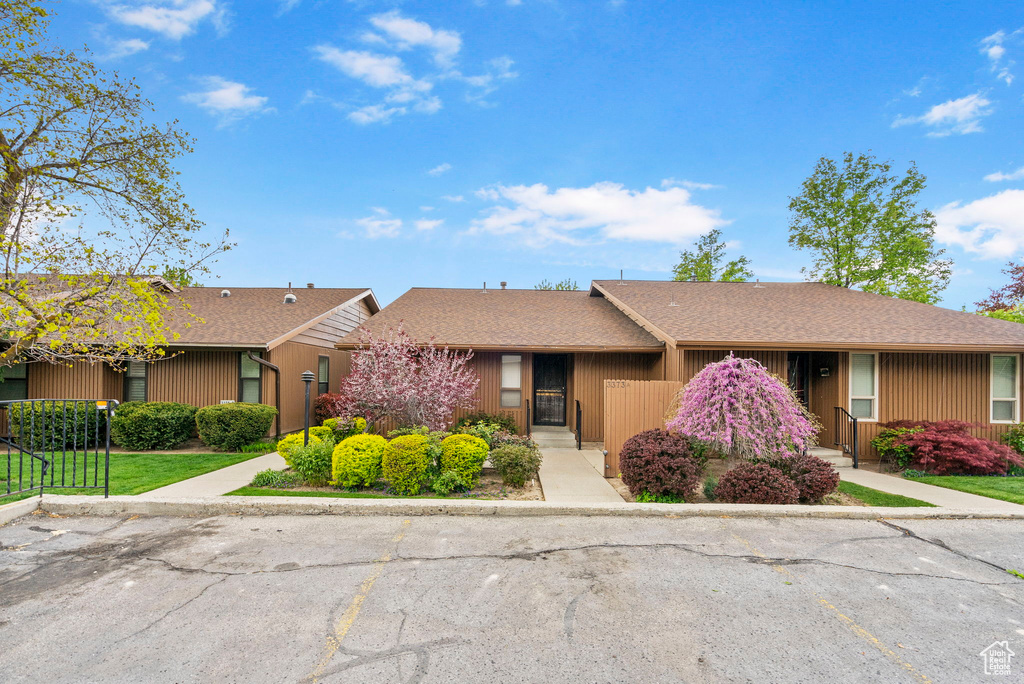 Ranch-style home with roof with shingles