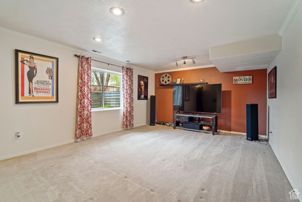Living area featuring visible vents, ornamental molding, carpet flooring, and baseboards