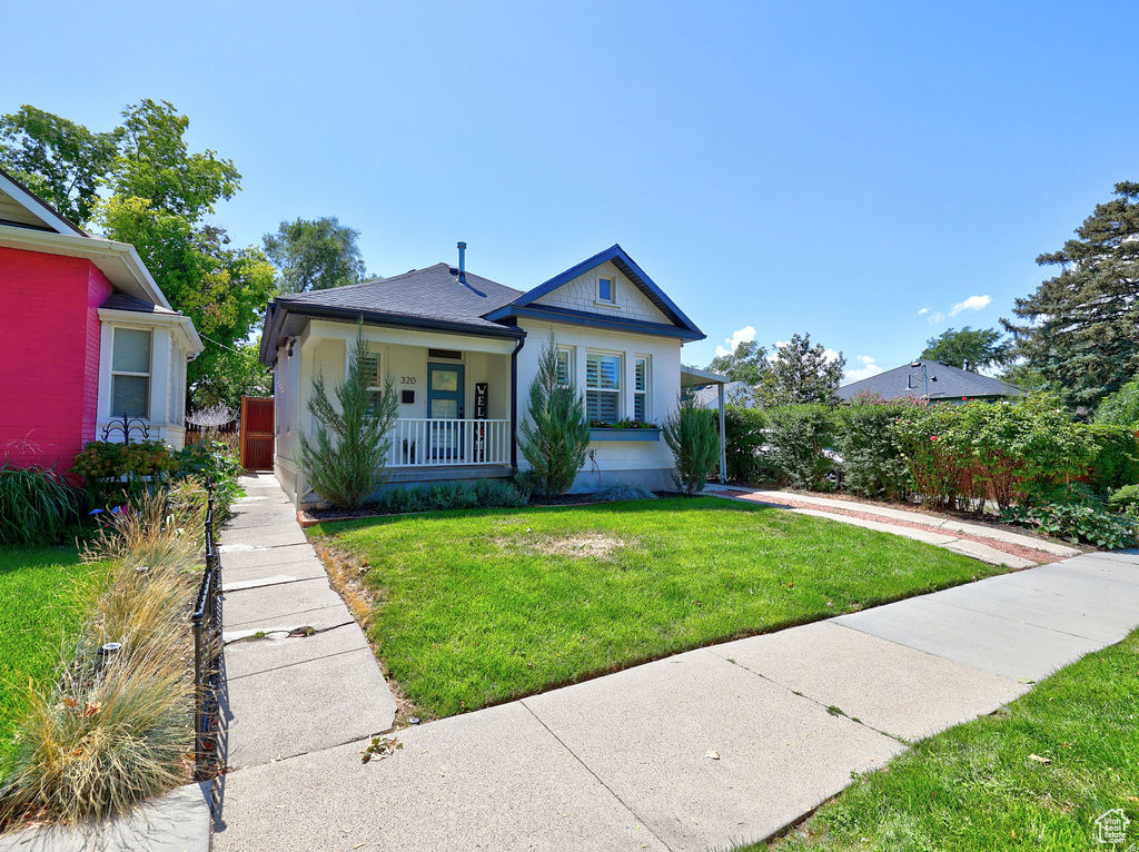 Bungalow-style home featuring a front yard and a porch