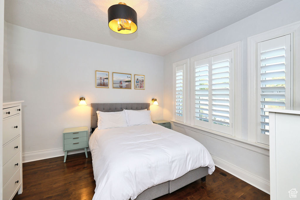 Bedroom featuring baseboards and wood finished floors