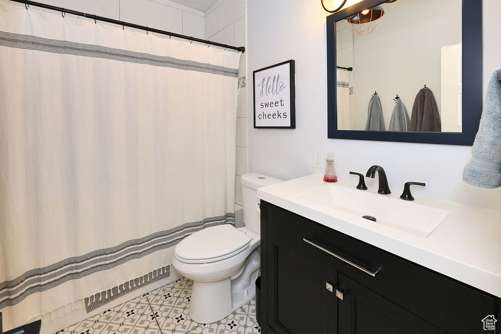 Full bathroom with toilet and vanity