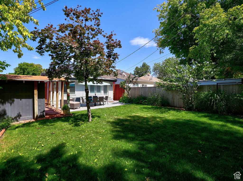 View of yard featuring a patio and fence