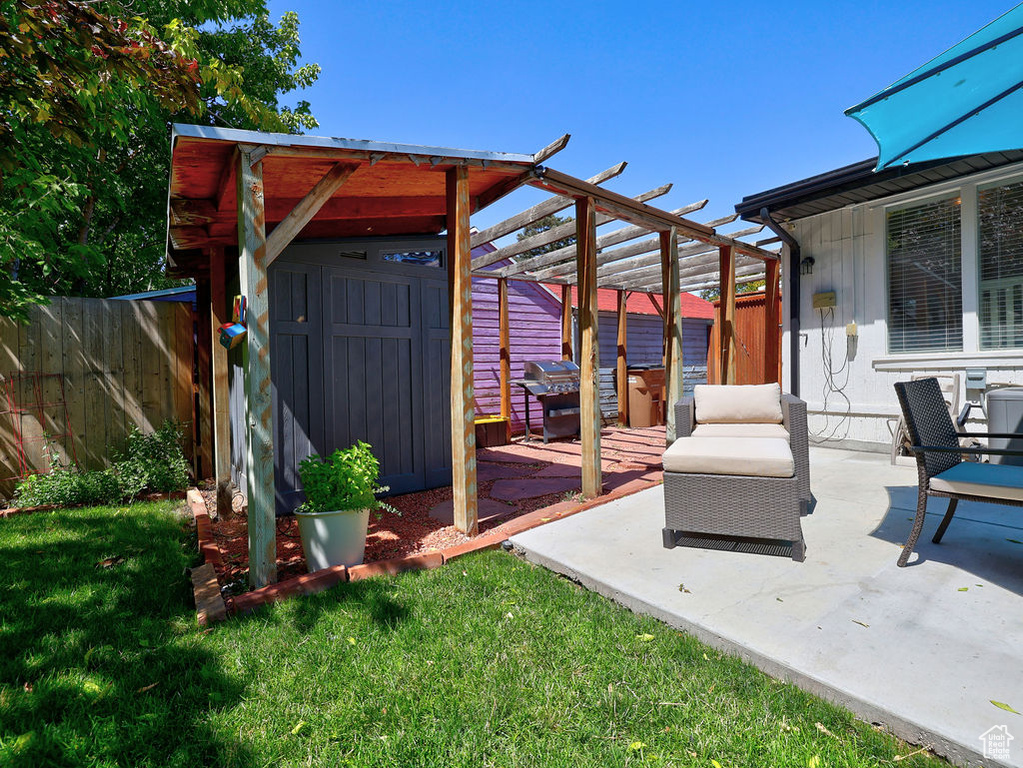 View of patio / terrace featuring an outdoor structure, fence, area for grilling, and a pergola