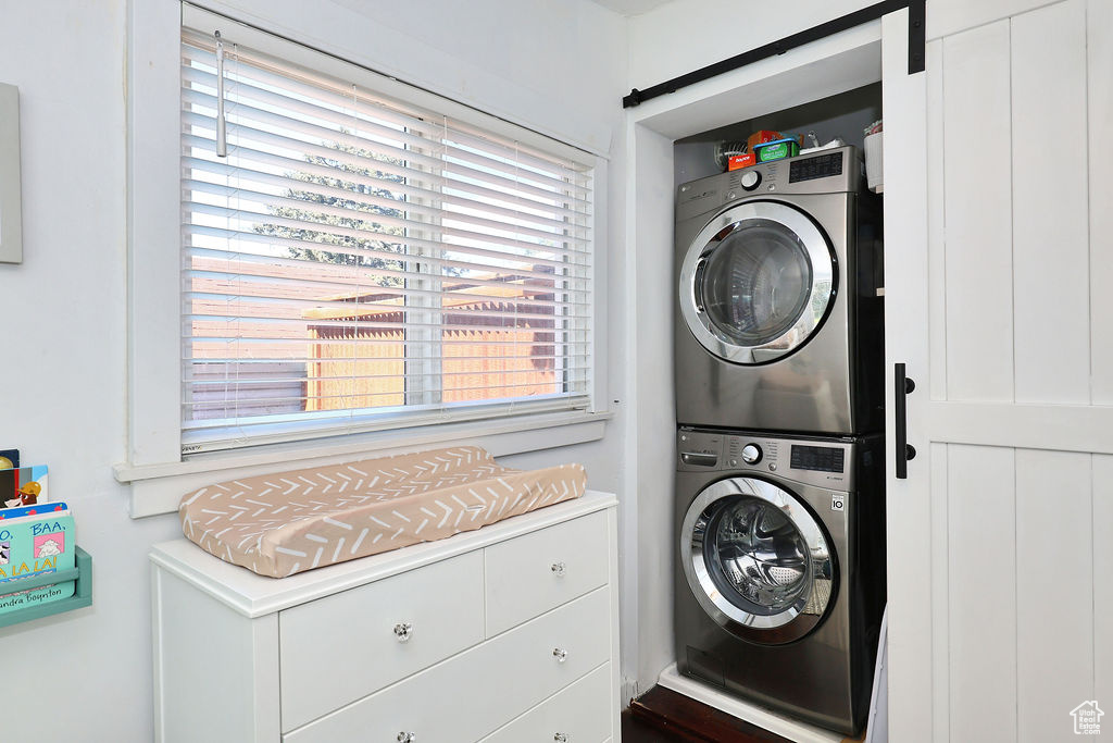 Laundry area featuring laundry area and stacked washer / drying machine