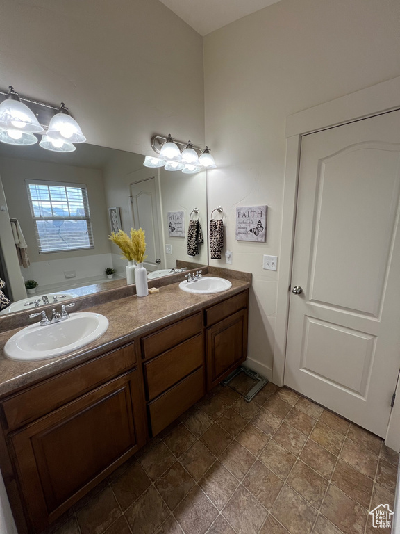 Bathroom with a sink, a bathing tub, and double vanity