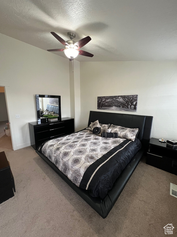 Bedroom featuring ceiling fan and carpet