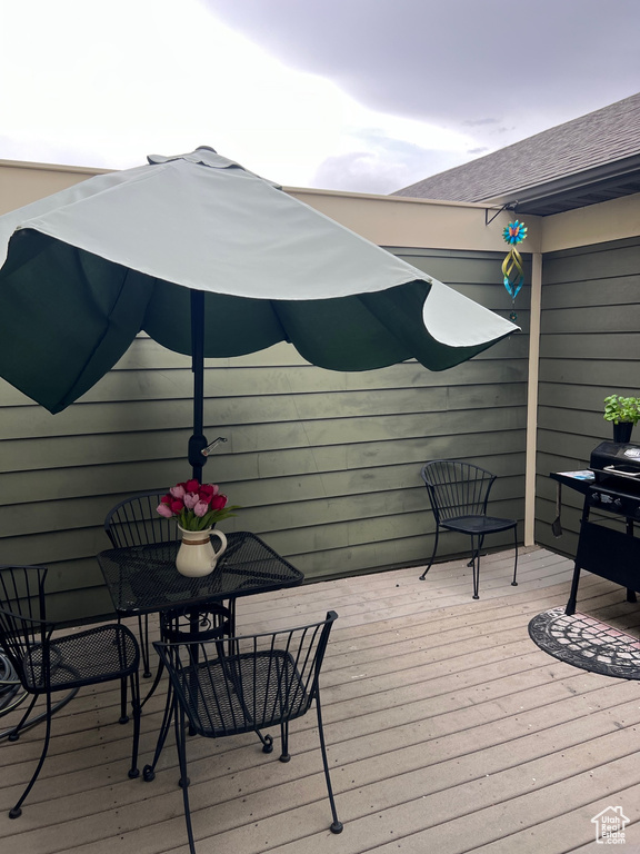 Wooden deck featuring outdoor dining space