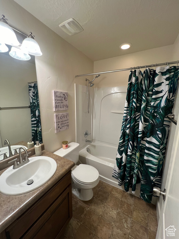 Bathroom with shower / bath combo, vanity, toilet, a textured ceiling, and visible vents