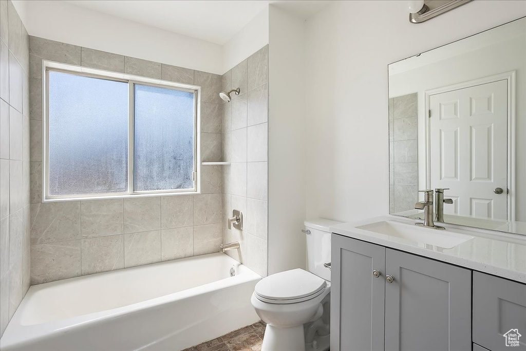 Full bathroom with bathing tub / shower combination, toilet, and vanity