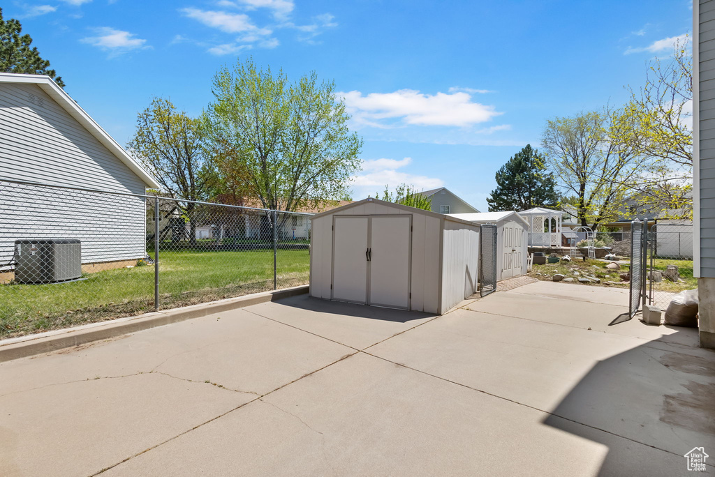 View of shed with central AC and fence