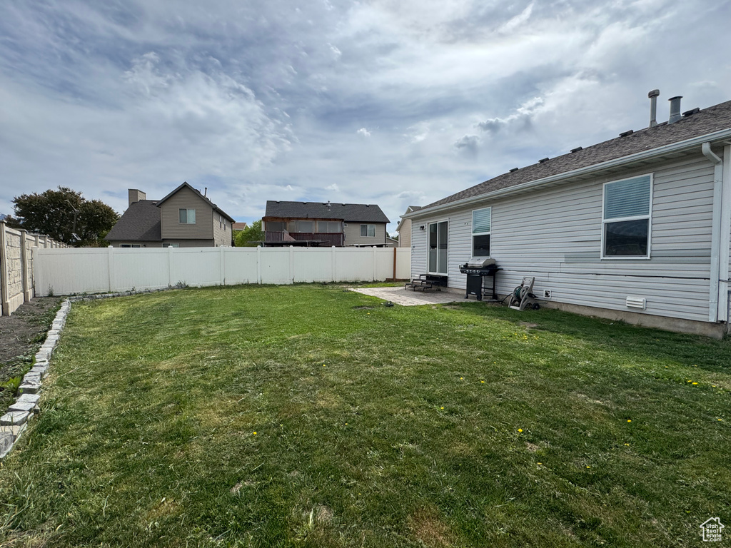 View of yard with a patio area and a fenced backyard