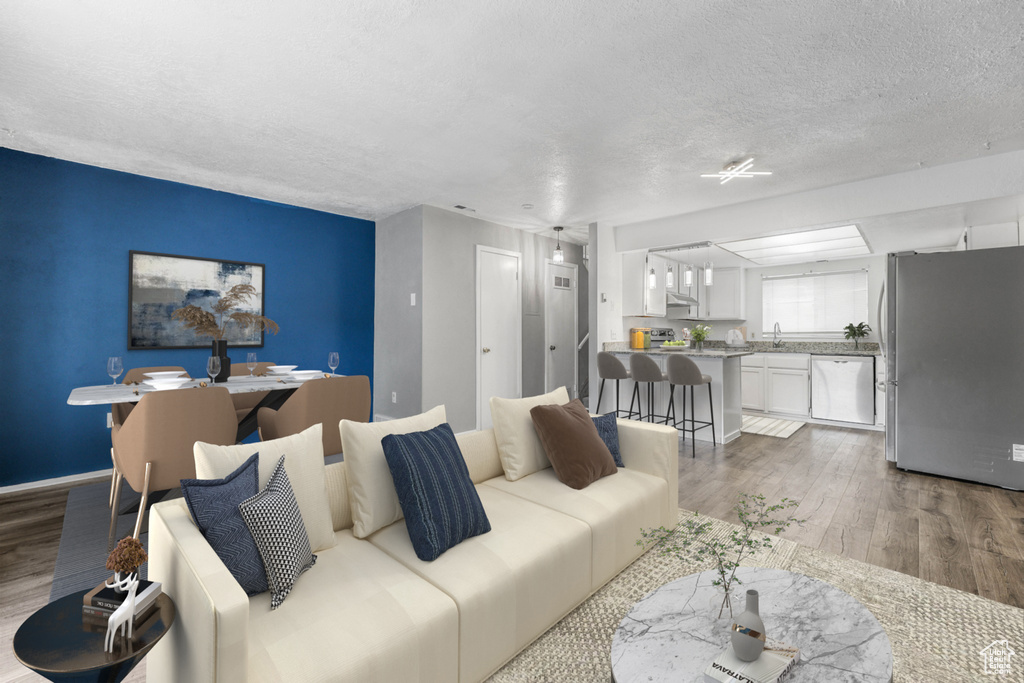 Living room with wood finished floors and a textured ceiling