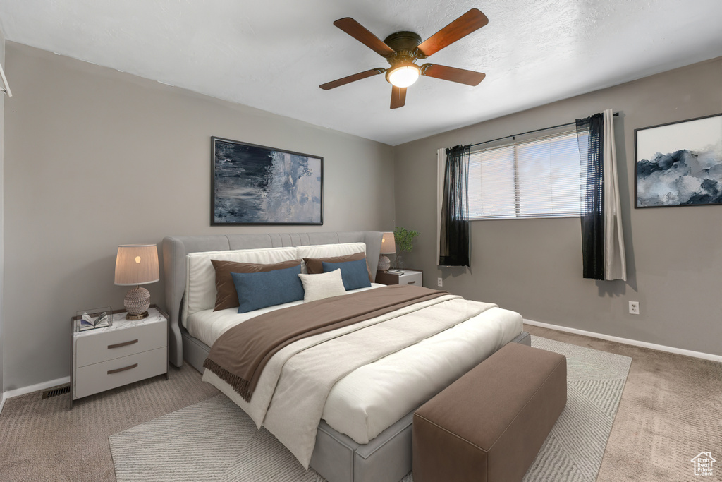 Bedroom with carpet floors, baseboards, and a ceiling fan