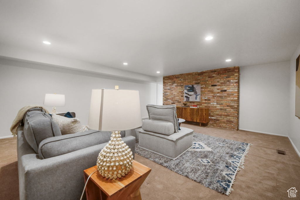 Carpeted living area with recessed lighting and visible vents