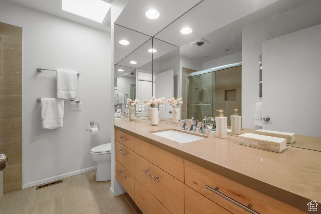 Full bath with recessed lighting, a shower stall, vanity, toilet, and visible vents