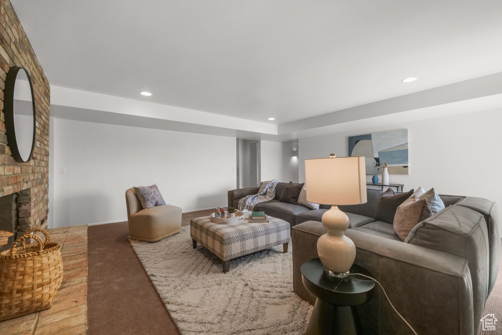 Carpeted living room featuring recessed lighting and a brick fireplace