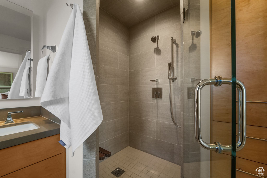 Bathroom with a shower stall and vanity