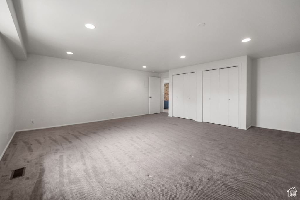 Unfurnished bedroom with recessed lighting, visible vents, multiple closets, and carpet floors