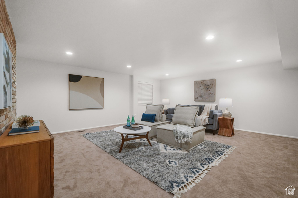 Carpeted living room featuring baseboards and recessed lighting