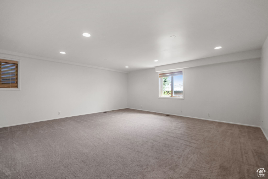 Carpeted spare room featuring recessed lighting and baseboards