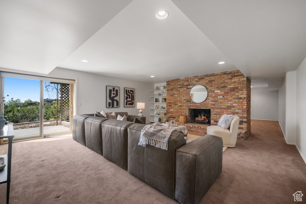 Carpeted living area featuring a fireplace, recessed lighting, and built in features