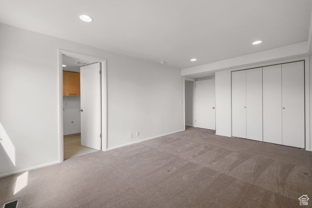 Unfurnished bedroom featuring recessed lighting, carpet flooring, a closet, visible vents, and baseboards