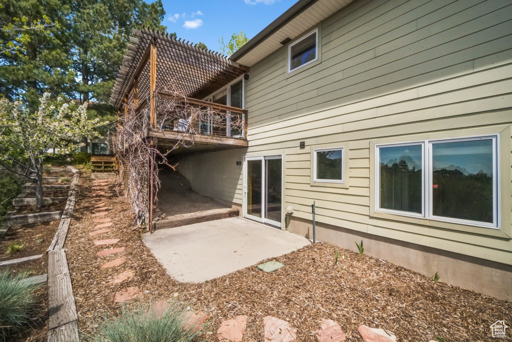 Back of property with a patio and a wooden deck
