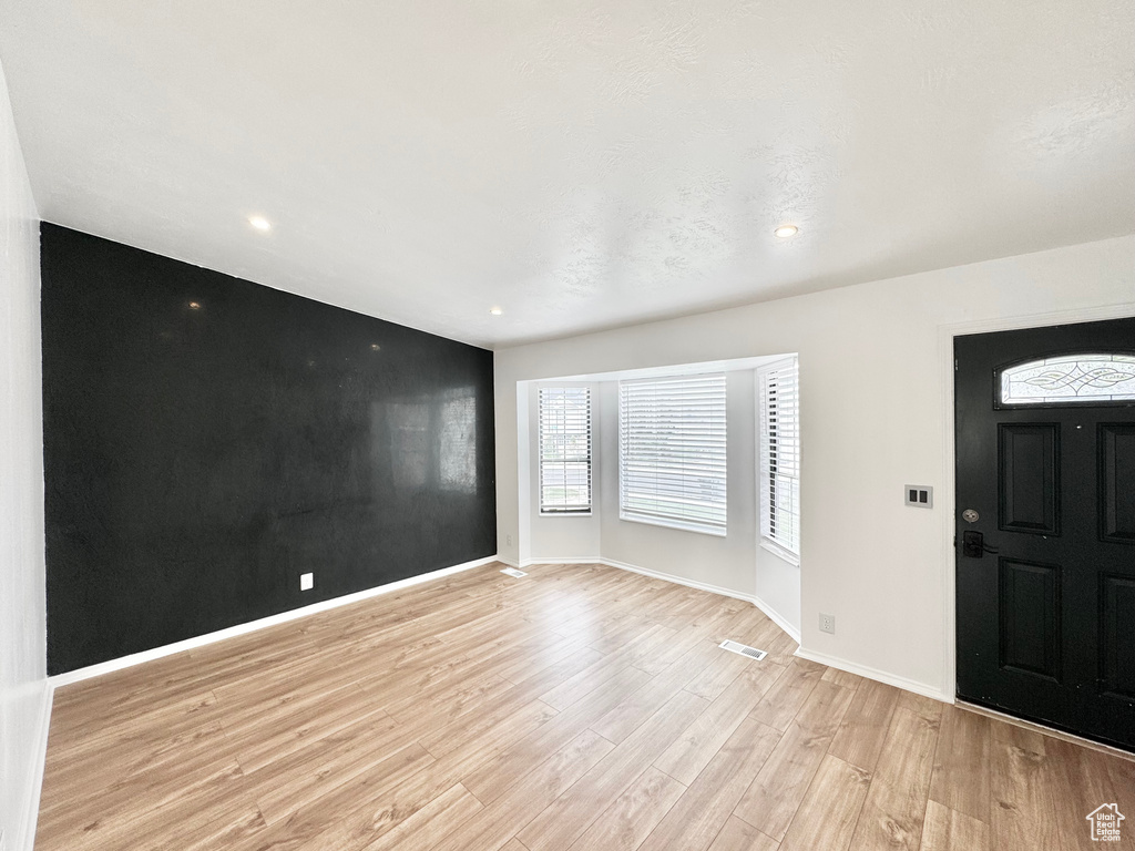 Entryway with baseboards, light wood-type flooring, and recessed lighting
