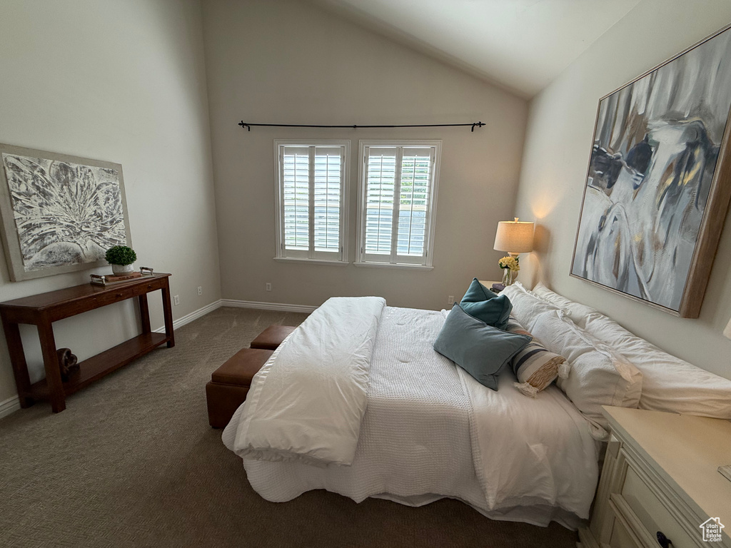 Bedroom featuring carpet flooring, vaulted ceiling, and baseboards