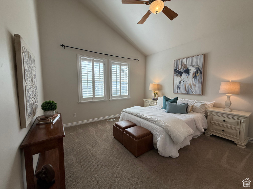 Bedroom with dark colored carpet, baseboards, high vaulted ceiling, and ceiling fan