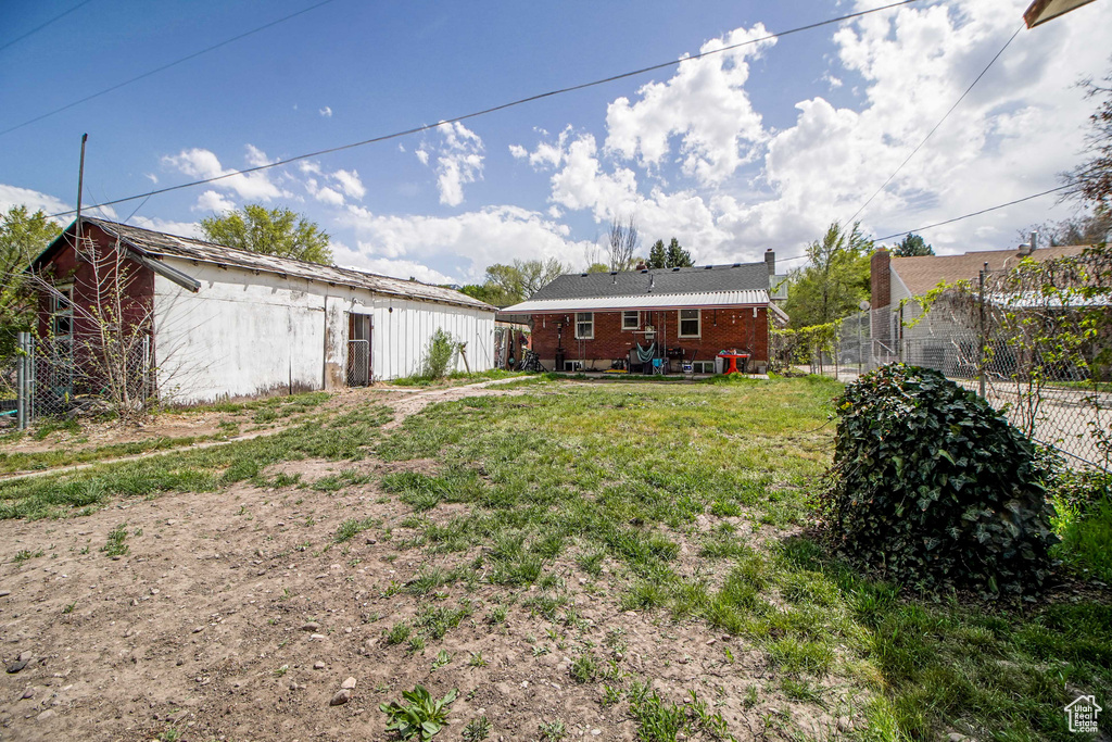 View of yard featuring fence and an outdoor structure