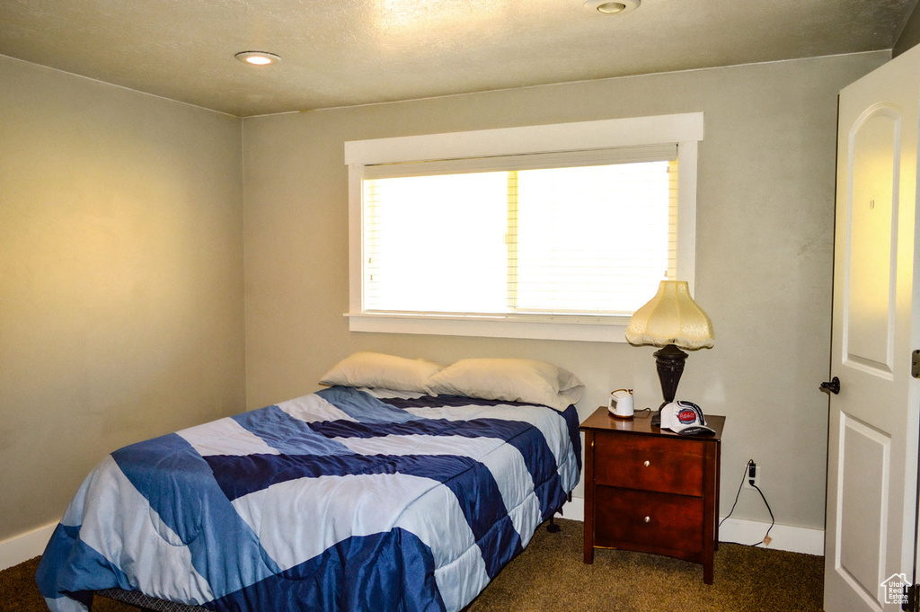 Carpeted bedroom with baseboards