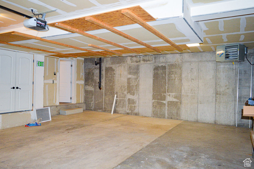 Garage featuring a garage door opener and visible vents